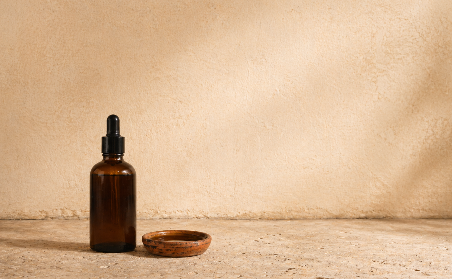 Amber glass dropper bottle on a stone surface