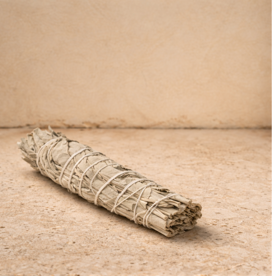 white sage smudge stick on hone cross cut travertine surface